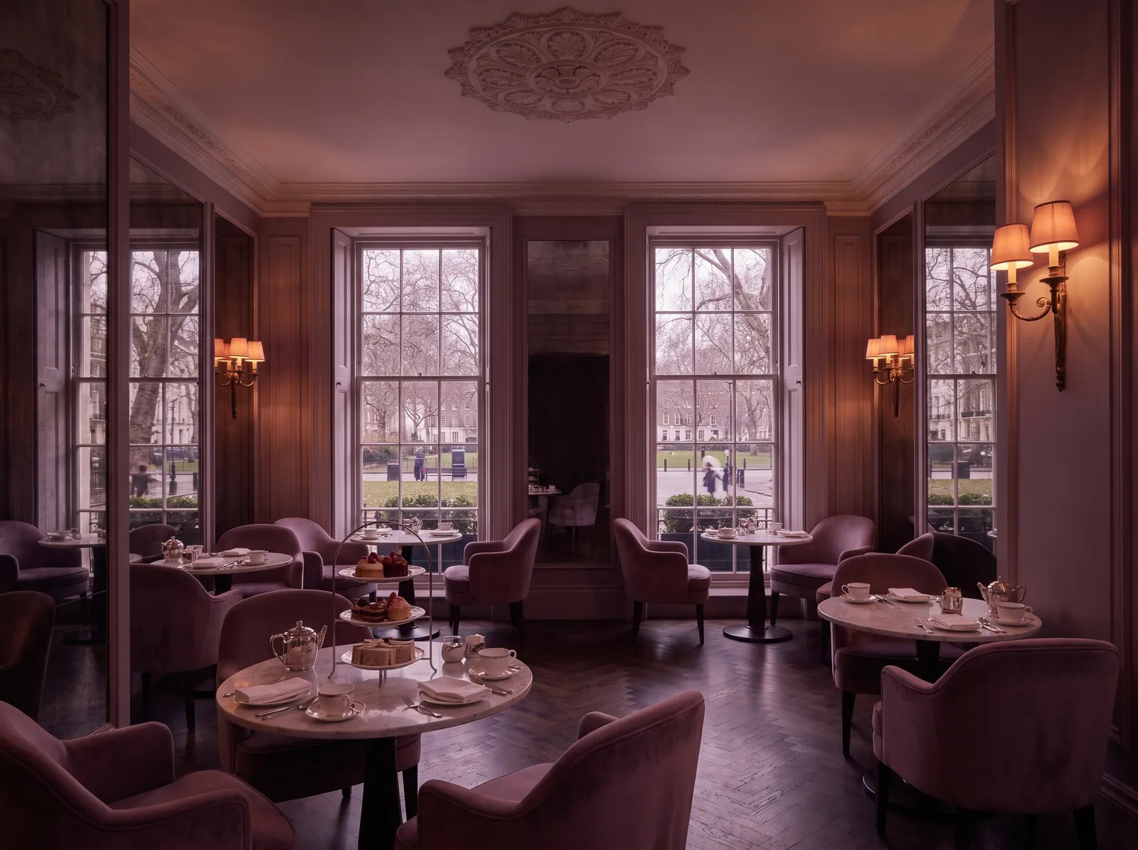 The Parlour: marble tea tables, a cake stand and velvet armchairs by the sash windows