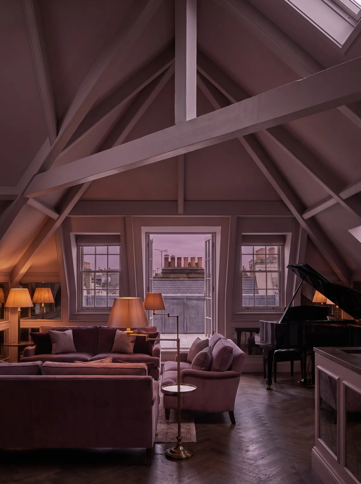 The Townhouse Penthouse: a beamed attic drawing room with velvet sofas, a grand piano and a door onto a rooftop terrace